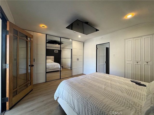 bedroom with hardwood / wood-style flooring and ornamental molding