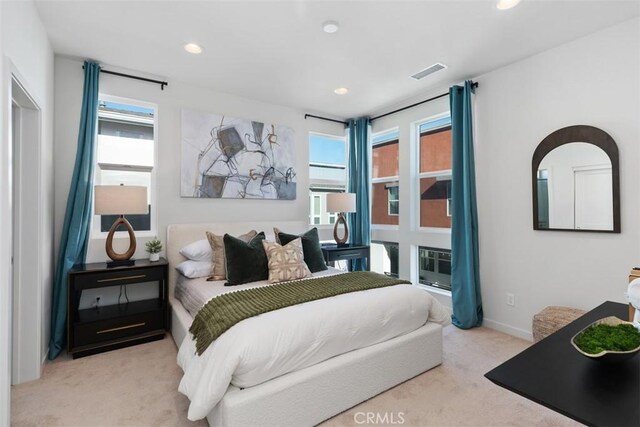 bedroom featuring light carpet