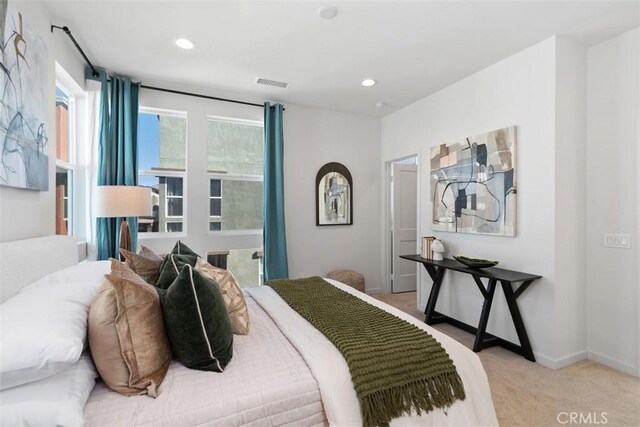 bedroom featuring light colored carpet