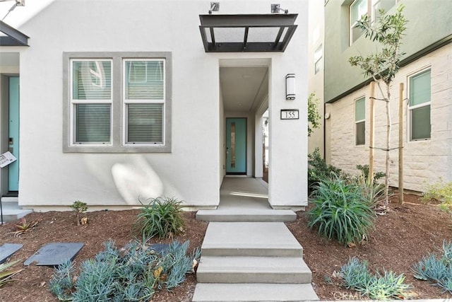 property entrance featuring stucco siding