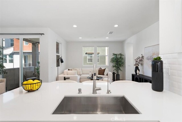 kitchen featuring plenty of natural light and sink