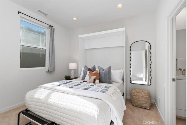 bedroom with light colored carpet