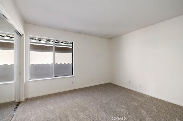 unfurnished room with a wealth of natural light and carpet flooring