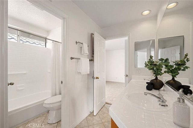 full bathroom with tile patterned floors, toilet, vanity, and shower / tub combo