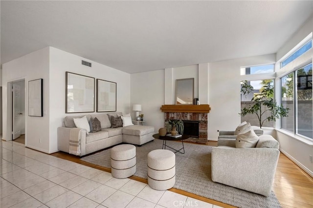 tiled living room featuring a fireplace