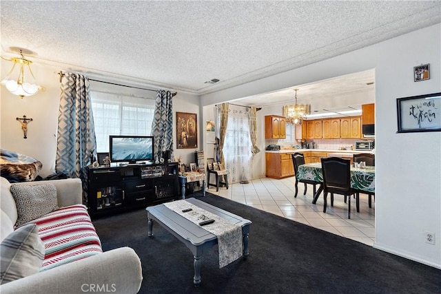 living room featuring a textured ceiling, a chandelier, and light tile patterned flooring