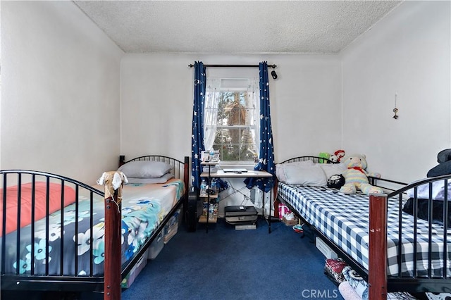 bedroom featuring dark carpet and a textured ceiling