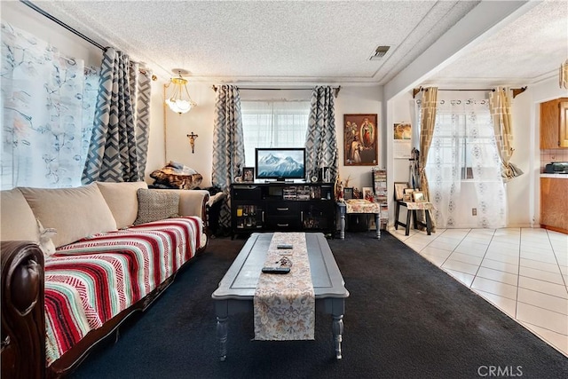 living room featuring a textured ceiling and tile patterned flooring