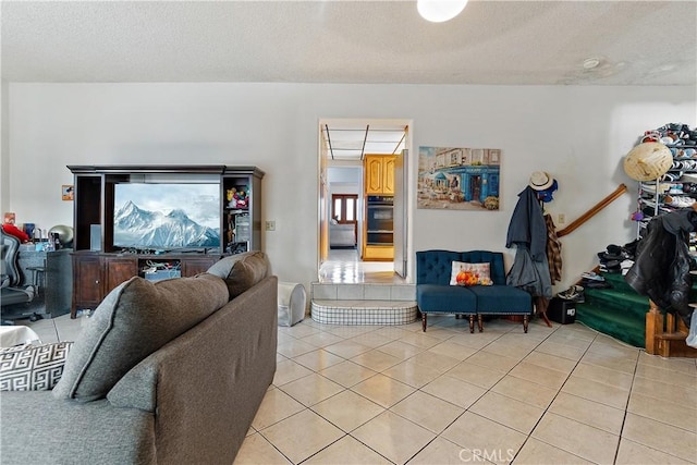 living room featuring a textured ceiling and light tile patterned flooring