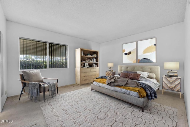 carpeted bedroom featuring a textured ceiling