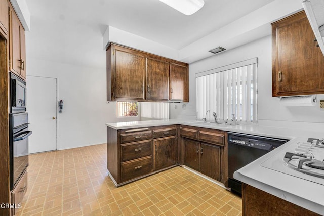 kitchen with black appliances, kitchen peninsula, dark brown cabinets, and sink