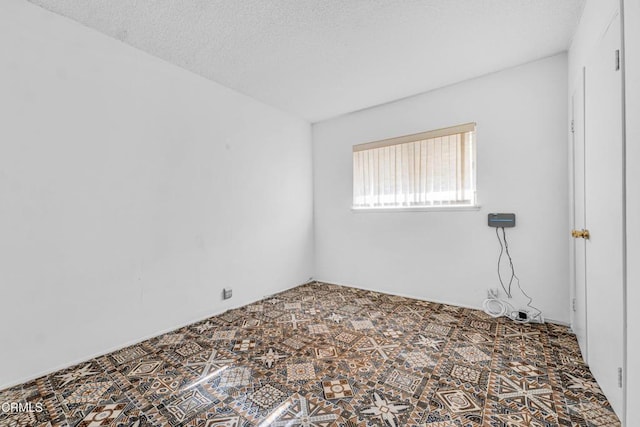 empty room with a textured ceiling