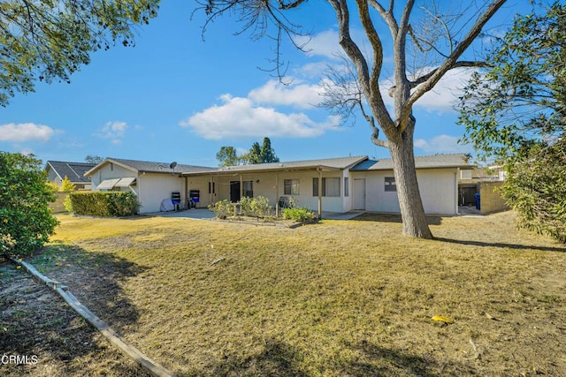 back of property featuring a yard