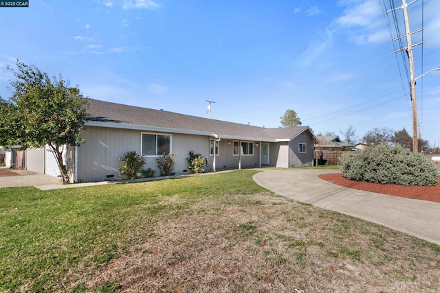 ranch-style home with a garage and a front lawn