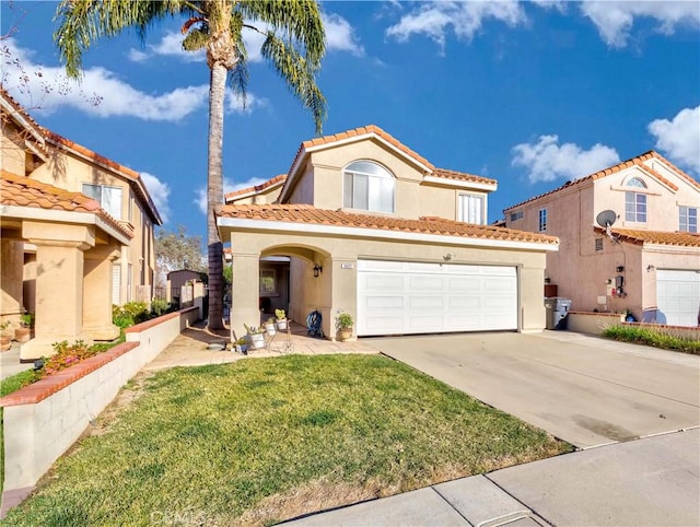 mediterranean / spanish-style home featuring a front yard and a garage