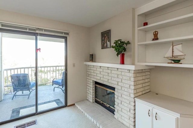 carpeted living room with a fireplace and built in features