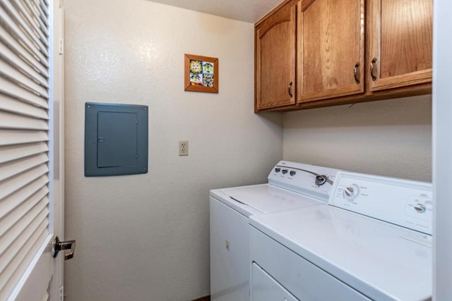 laundry room with cabinets, electric panel, and washing machine and clothes dryer