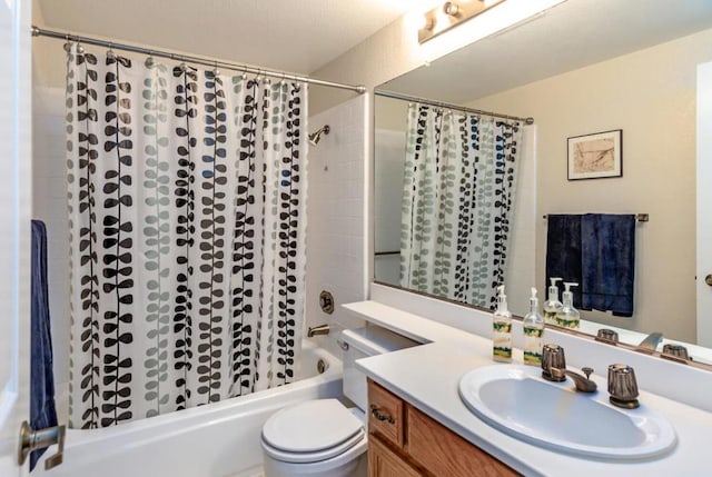 full bathroom featuring shower / tub combo with curtain, vanity, and toilet