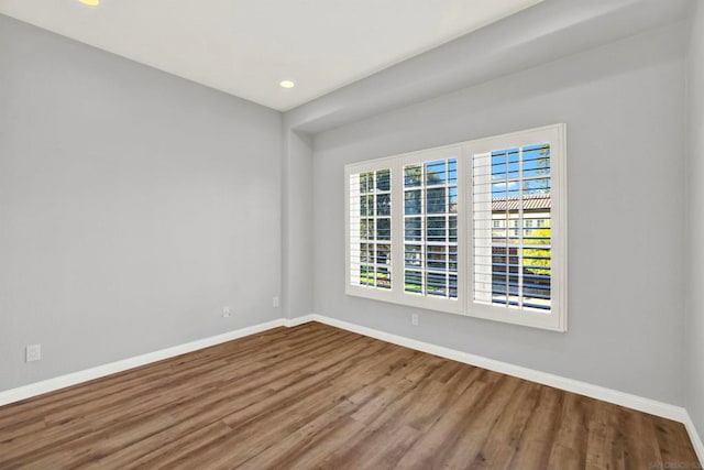 empty room with hardwood / wood-style floors