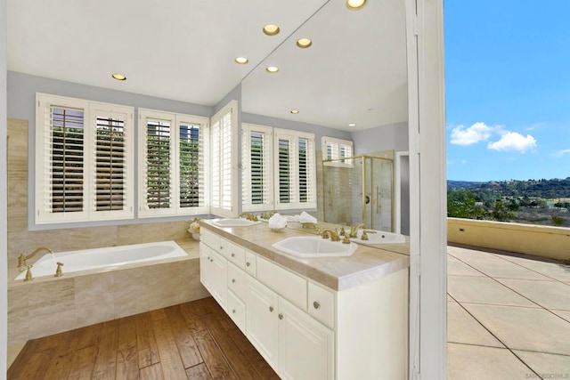 bathroom featuring independent shower and bath, vanity, and hardwood / wood-style floors