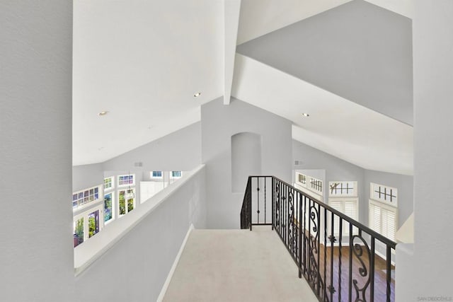 corridor with vaulted ceiling with beams