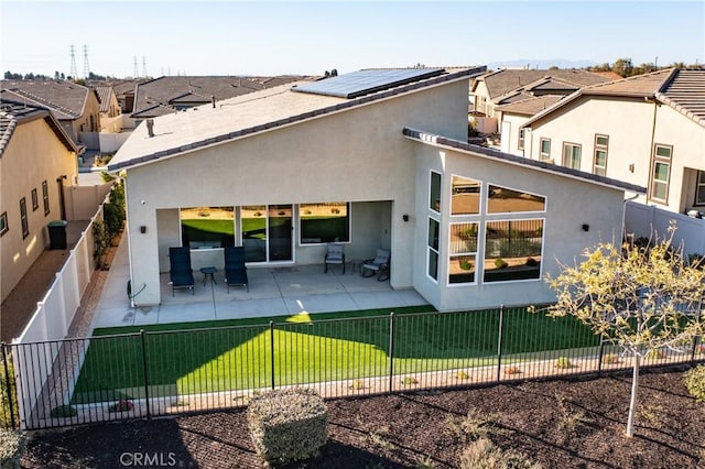 rear view of house with a patio area and a lawn