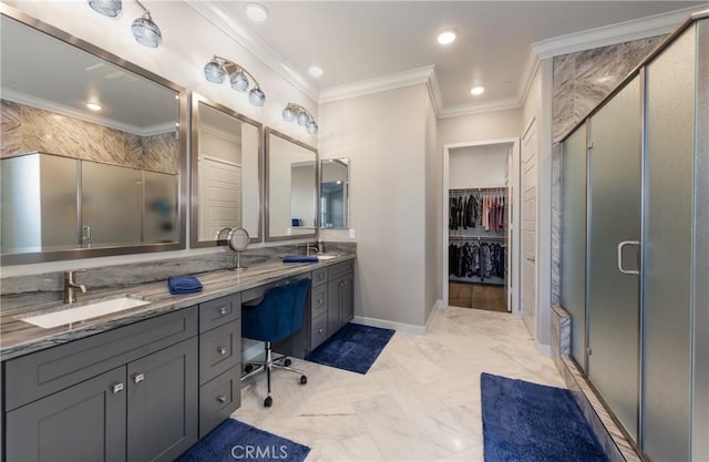 bathroom featuring a shower with shower door, vanity, and ornamental molding