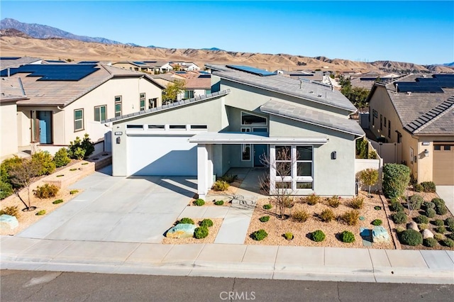 view of front of house featuring a garage and a mountain view