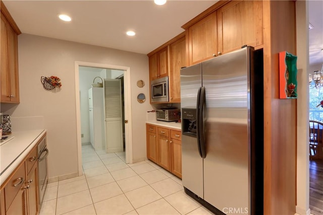 kitchen with light tile patterned floors and appliances with stainless steel finishes