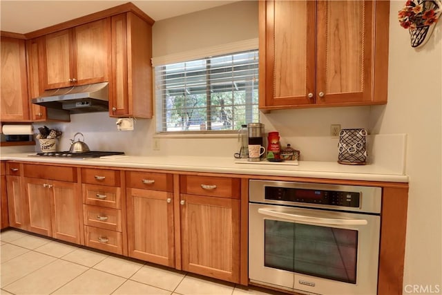 kitchen featuring light tile patterned floors and stainless steel appliances