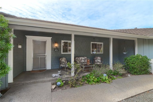 doorway to property featuring a porch