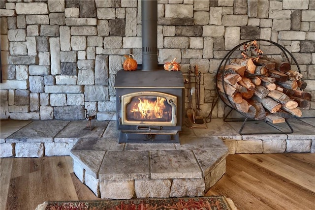 interior details featuring hardwood / wood-style flooring and a wood stove