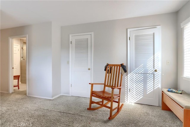 sitting room featuring light colored carpet