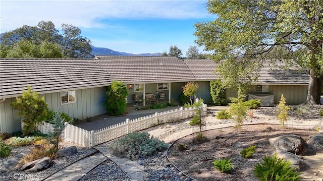 back of house featuring a mountain view and a patio