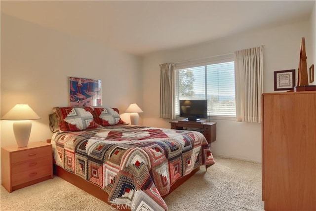 bedroom featuring light carpet