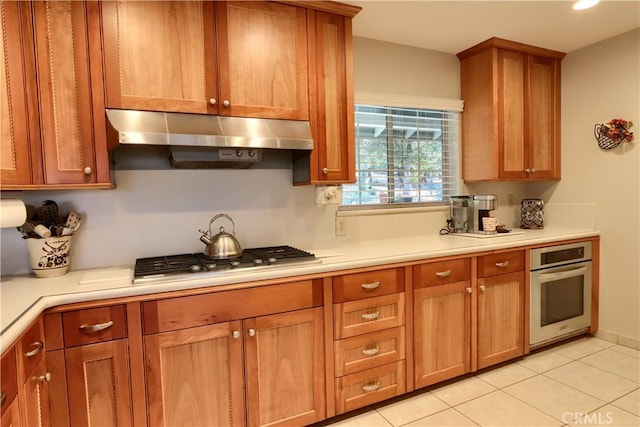 kitchen with light tile patterned flooring and stainless steel appliances