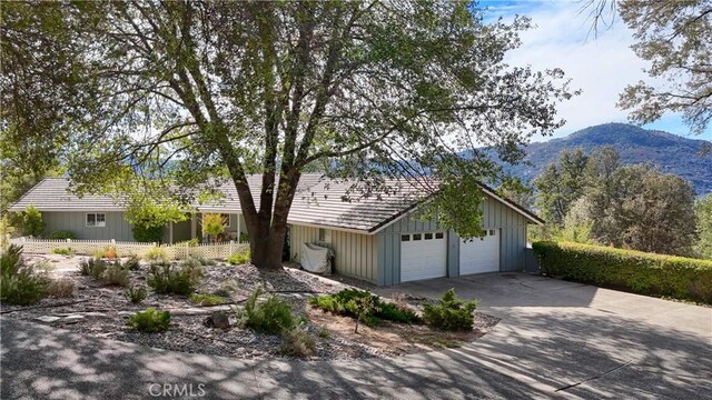 single story home with a mountain view and a garage