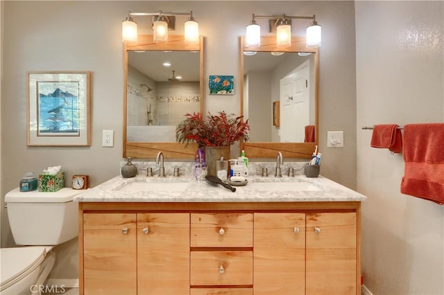 bathroom featuring vanity, toilet, and walk in shower