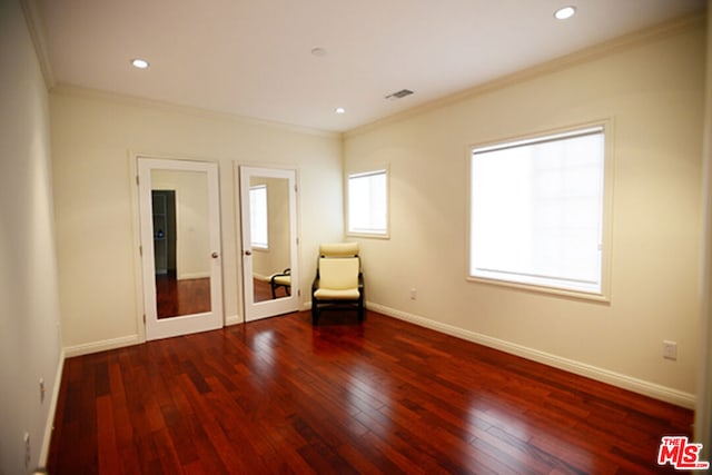 unfurnished room with crown molding and dark wood-type flooring