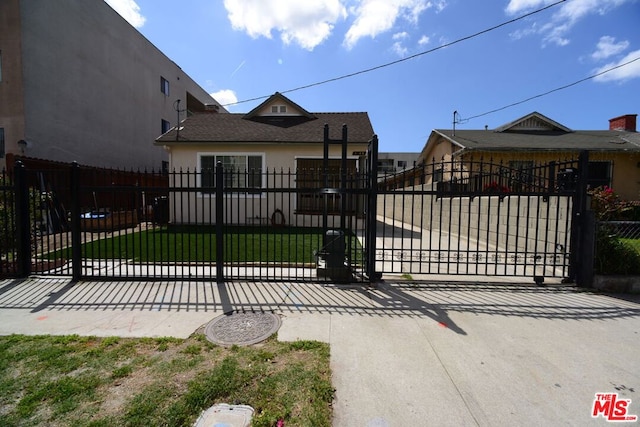 view of gate featuring a yard