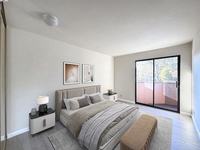 bedroom featuring hardwood / wood-style flooring and access to exterior