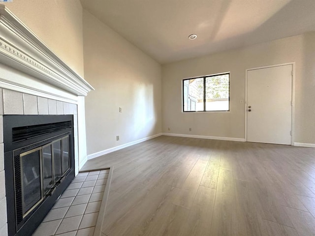 unfurnished living room with a fireplace and light hardwood / wood-style floors