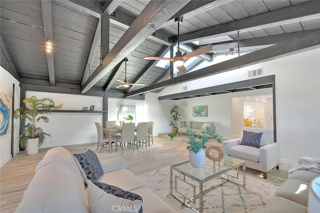 living room featuring ceiling fan, vaulted ceiling with beams, wooden ceiling, and light hardwood / wood-style flooring