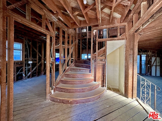 misc room with vaulted ceiling and hardwood / wood-style flooring