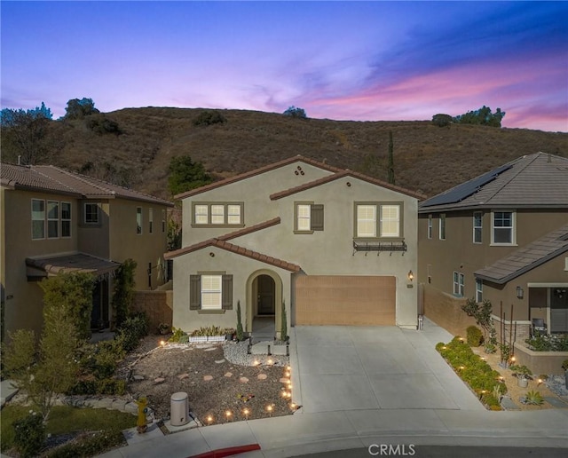 view of front of property featuring a garage and a mountain view