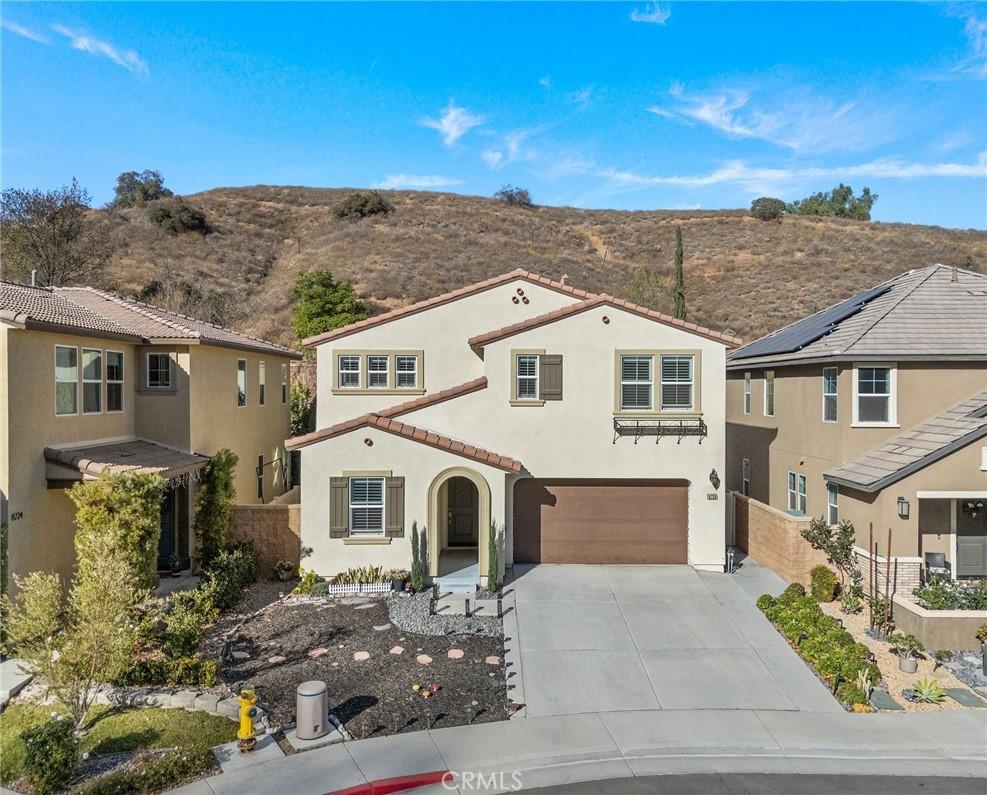 mediterranean / spanish-style home with a garage