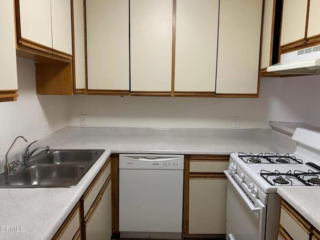 kitchen featuring white cabinets, white appliances, and sink