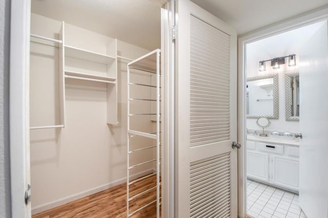 walk in closet with light tile patterned flooring