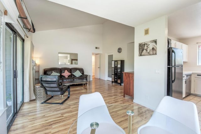 living room with lofted ceiling and light hardwood / wood-style floors