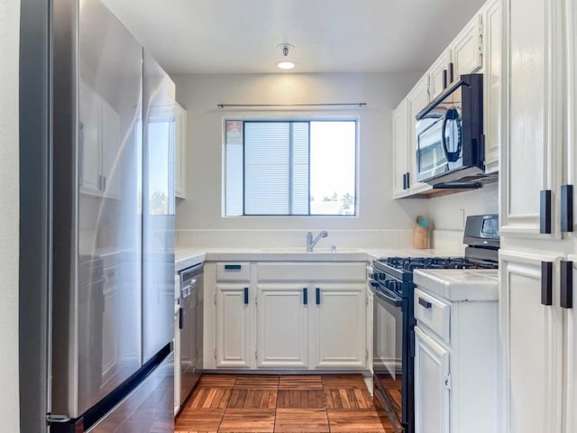 kitchen with white cabinets, sink, and black appliances